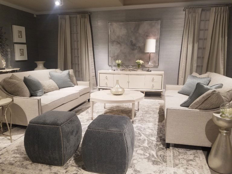 Bernhardt showroom filled with cream furniture and rugs and gray stools