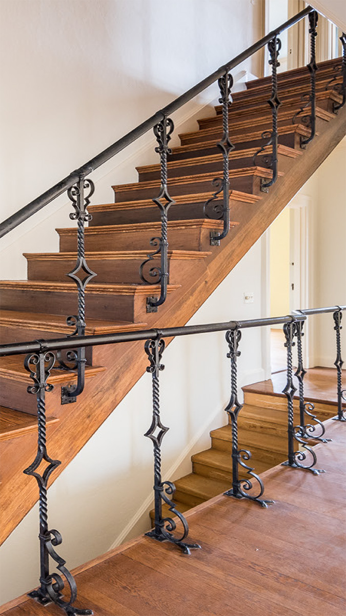 Green Front interiors project, staircase with iron railing