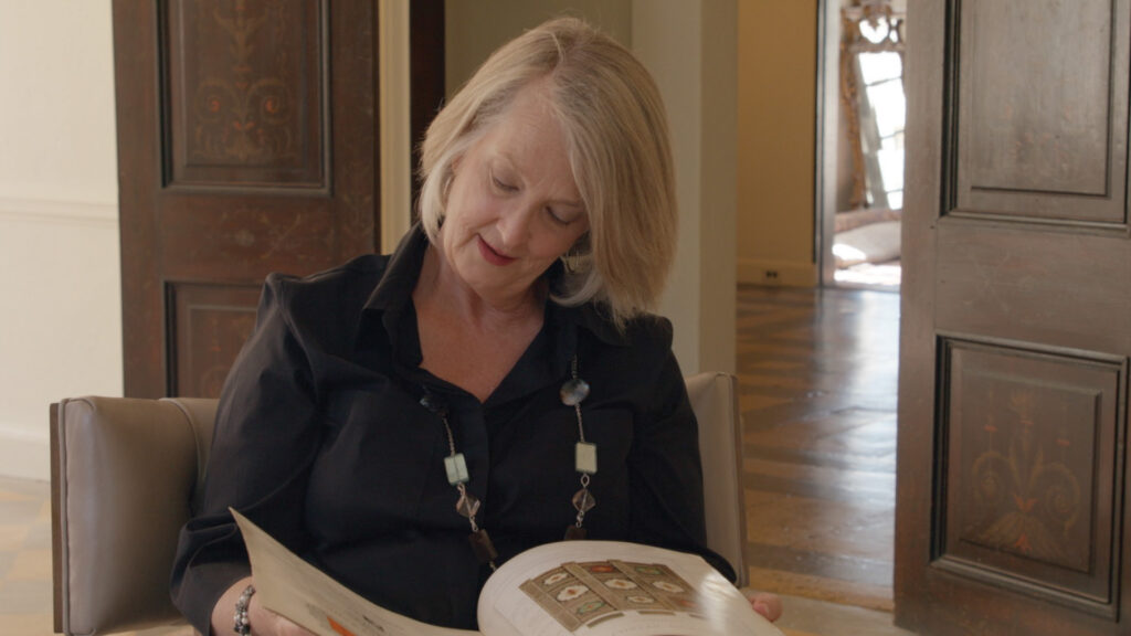 Woman reading a book about Spanish inspired traditional furniture